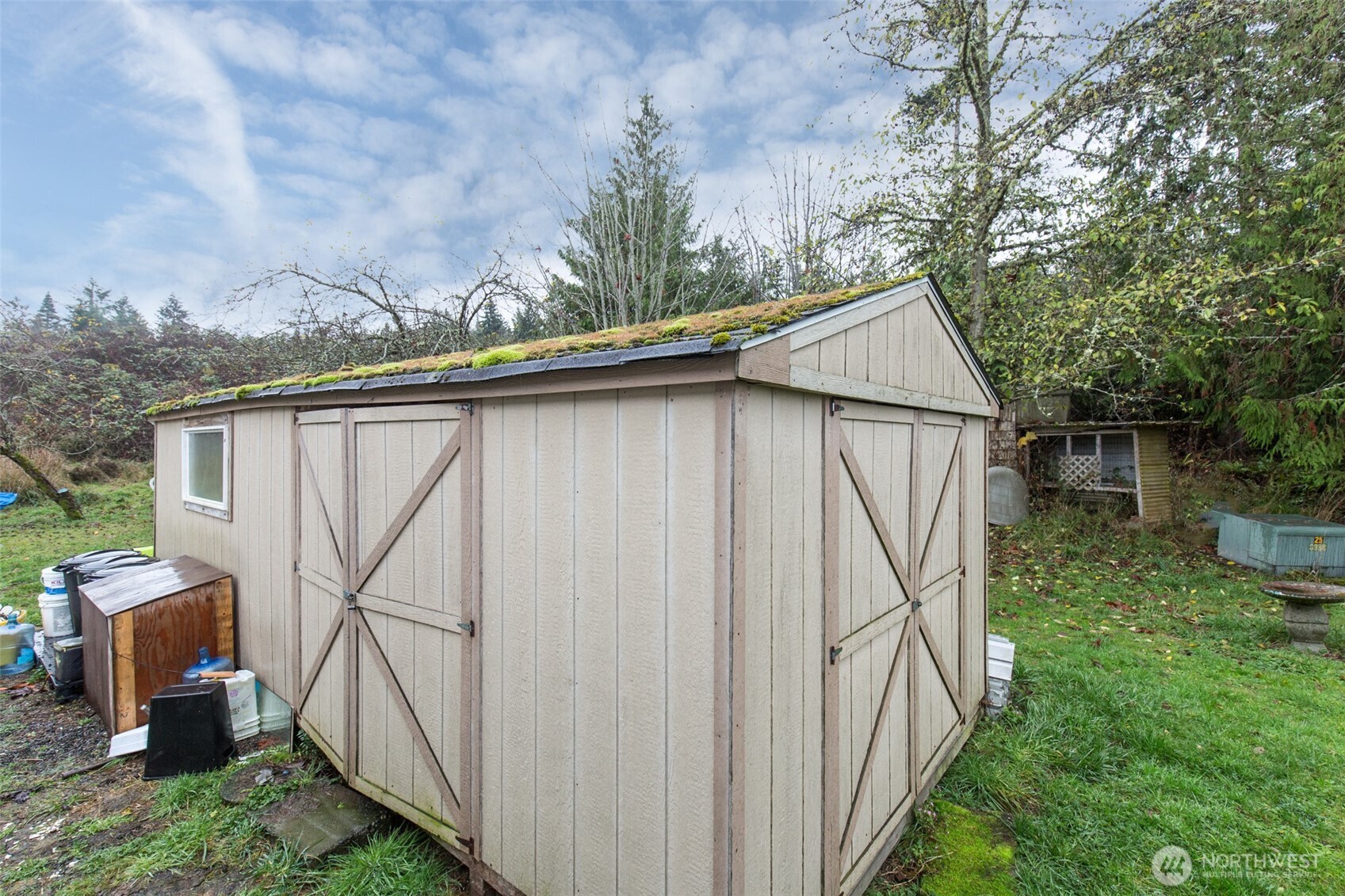 501 McCarver Road Port Angeles, WA 98362 - Photo 31 of 36 a backyard of a house with lots of green space and fountain