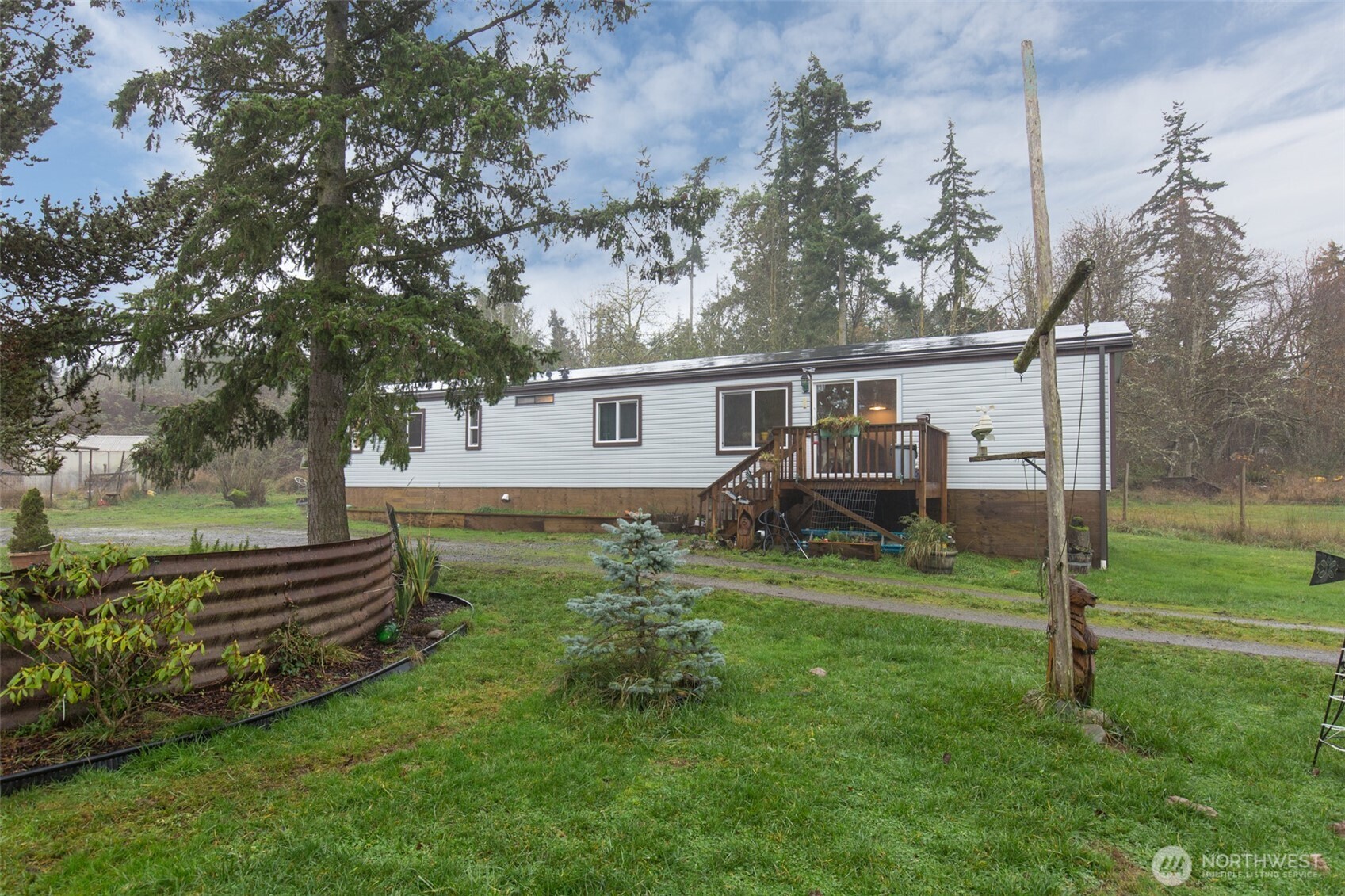 501 McCarver Road Port Angeles, WA 98362 - Photo 34 of 36 a view of a backyard with plants and a garden