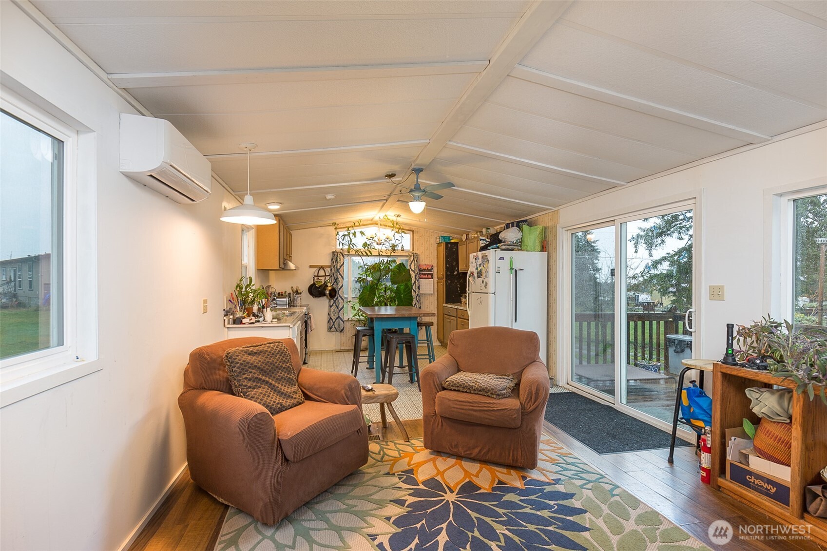 501 McCarver Road Port Angeles, WA 98362 - Photo 4 of 36 a living room with furniture a fireplace and a floor to ceiling window