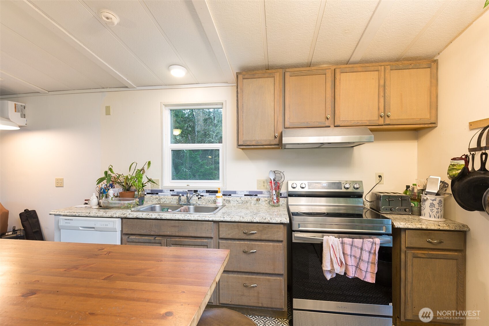 501 McCarver Road Port Angeles, WA 98362 - Photo 7 of 36 a kitchen with stainless steel appliances granite countertop a stove a sink and a white cabinets