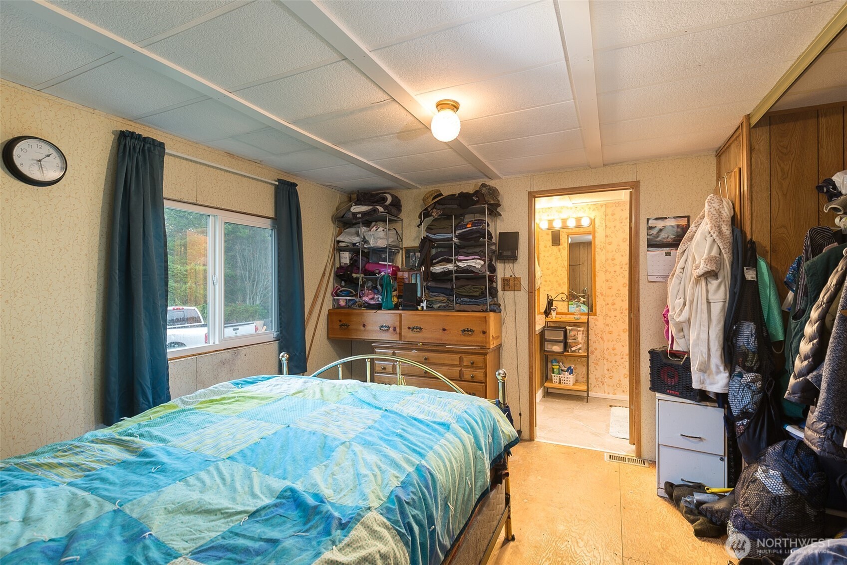 501 McCarver Road Port Angeles, WA 98362 - Photo 10 of 36 a bedroom with a large bed and a flat tv screen