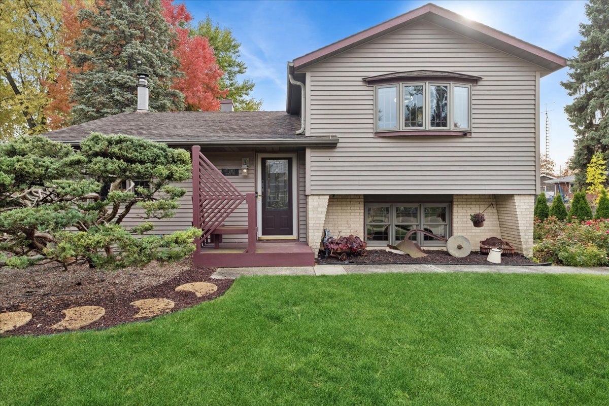 2813 Theresa Avenue Waukegan, IL 60085 - Photo 1 of 23 a front view of a house with a garden and sitting area