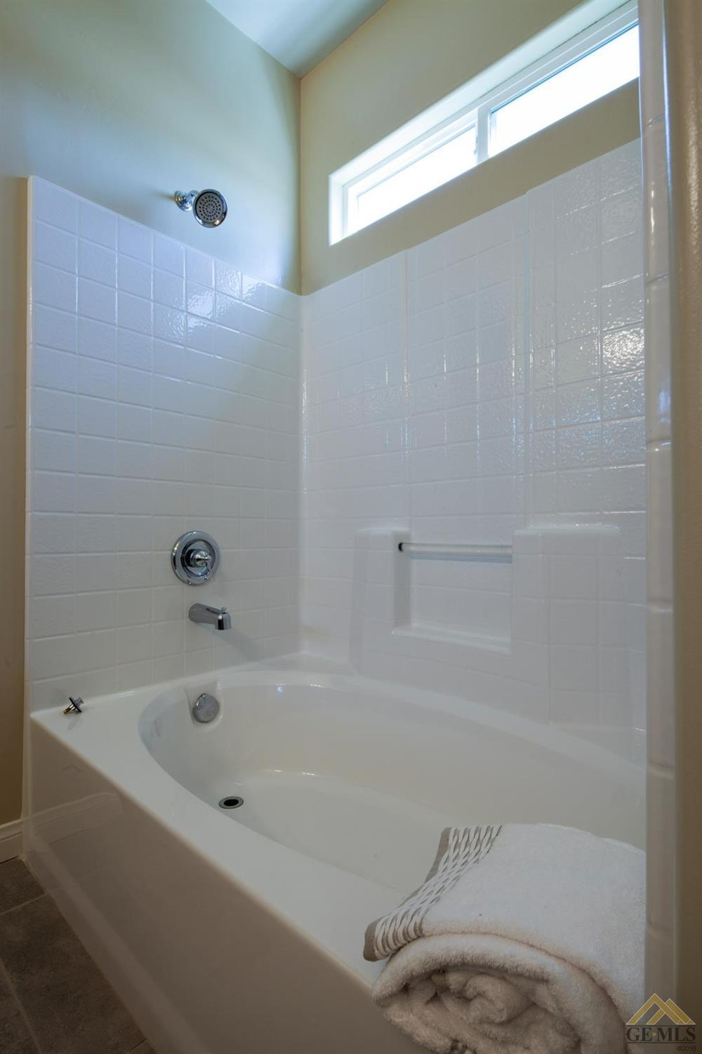 Undisclosed Address Bakersfield, CA 93313 - Photo 3 of 5 a bathroom with a bathtub and a shower