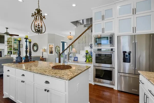a kitchen with stainless steel appliances granite countertop a sink and a refrigerator