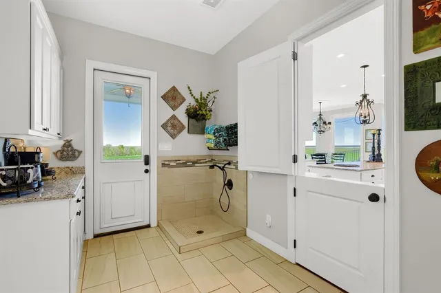 a en suite bathroom with a granite countertop sink and a mirror
