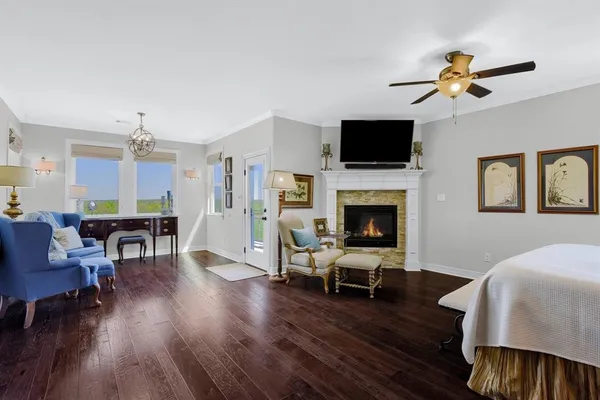 a living room with furniture fireplace and flat screen tv