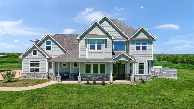 a front view of a house with a yard and porch