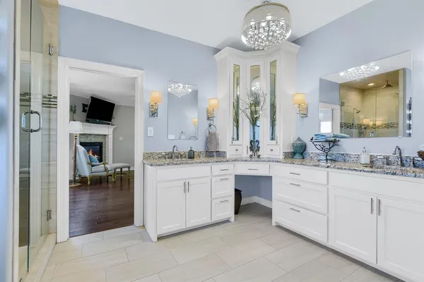 a spacious bathroom with a granite countertop sink a mirror and a
