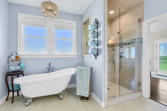 a bathroom with a bathtub and shower