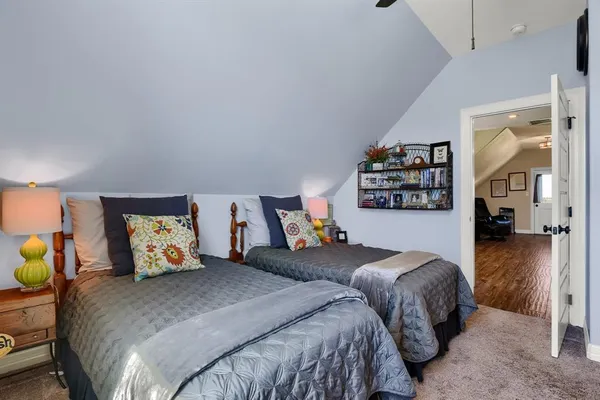 a bedroom with two beds and painting on the wall