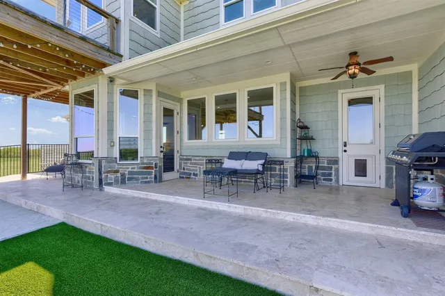 a view of a house with backyard porch and sitting area