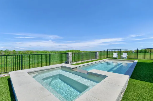 a view of swimming pool with a yard and sitting area