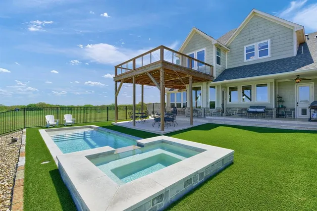 a view of a house with pool and chairs