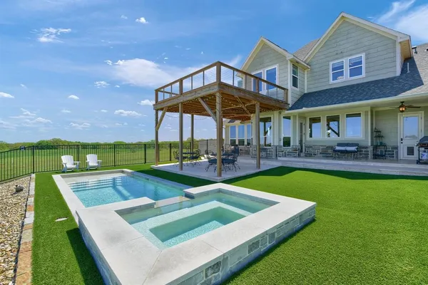 a view of a house with pool and chairs
