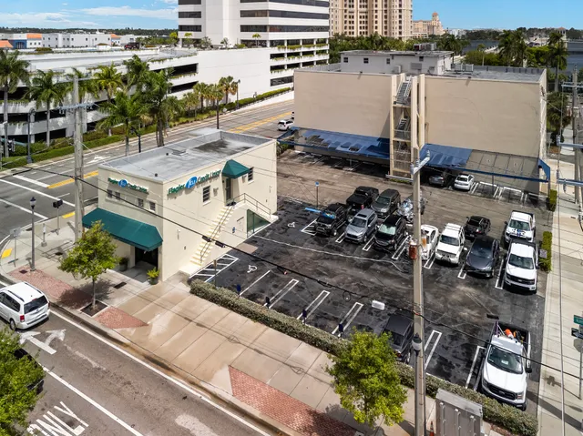 a couple of cars parked in front of a building