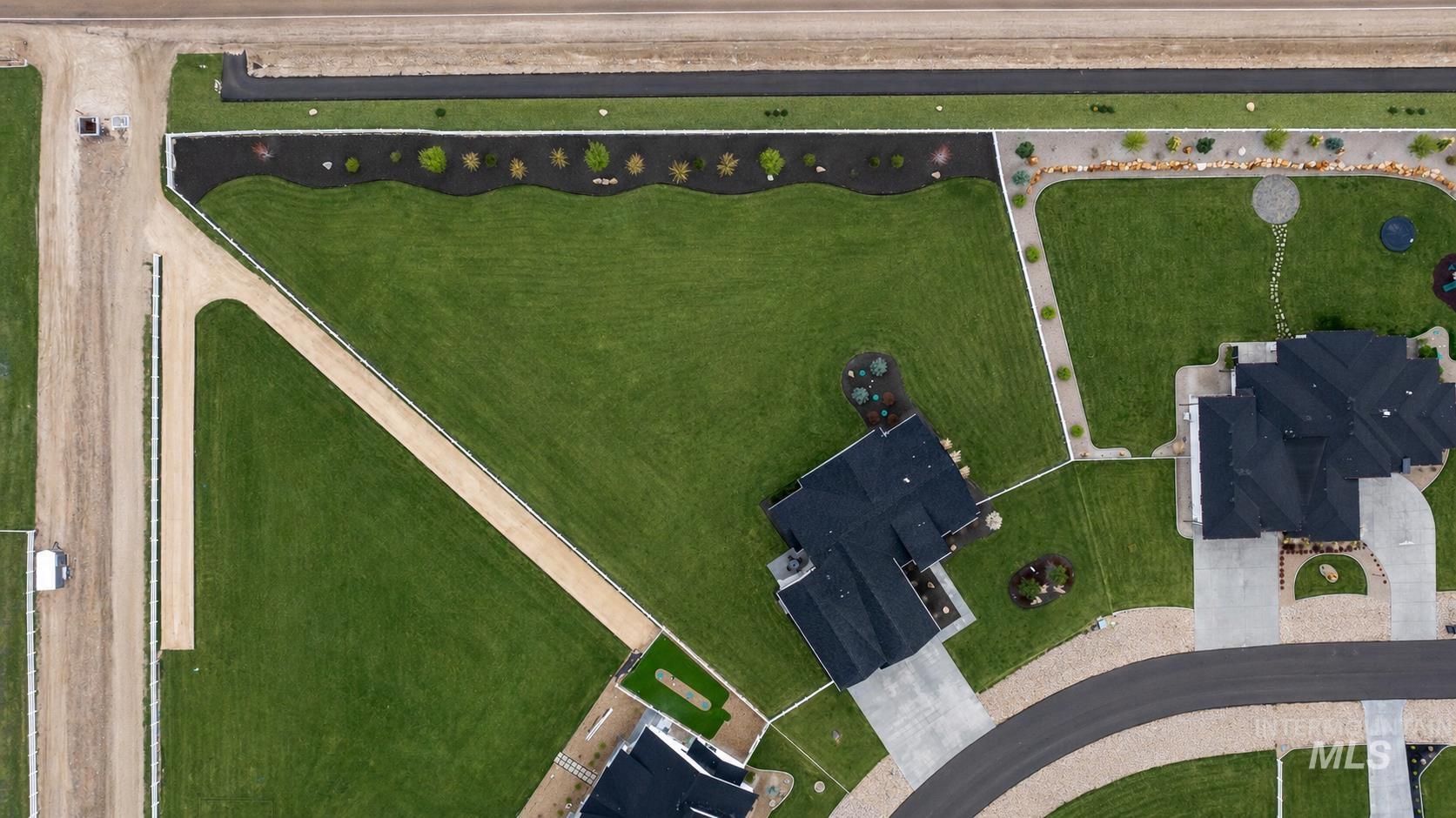 24696 Regal Road Middleton, ID 83644 - Photo 20 of 24 Expansive lot featuring a large manicured lawn, established landscaping, and a gravel pathway
