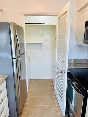 a view of a kitchen from a hallway