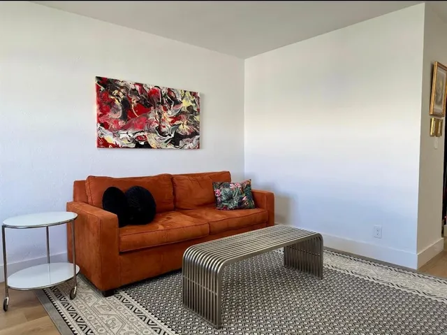 a blue couch sitting next to a small bathroom