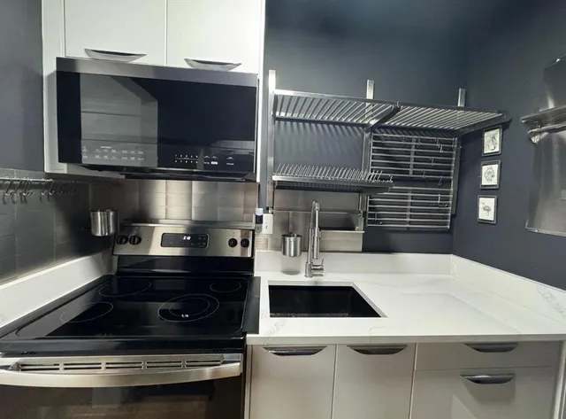 a kitchen with a stove and a microwave