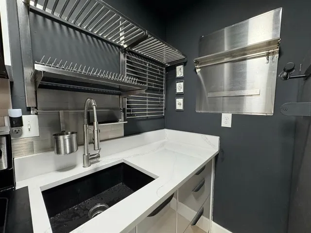 a kitchen with a sink and cabinets