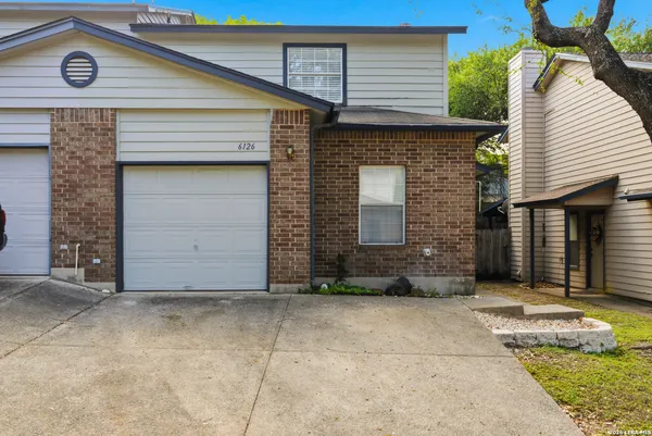 a front view of a house with garage