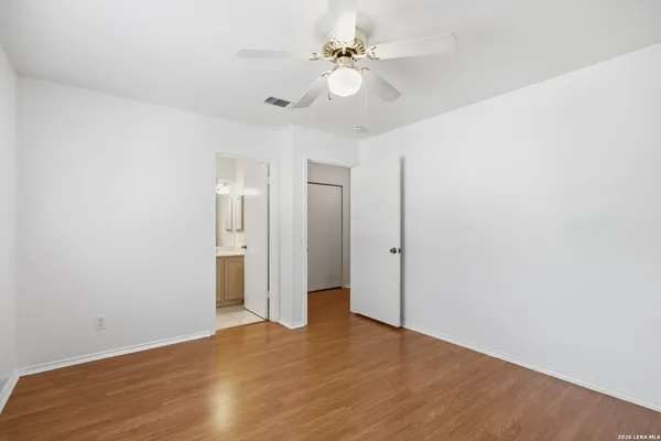 a view of an empty room with a ceiling fan