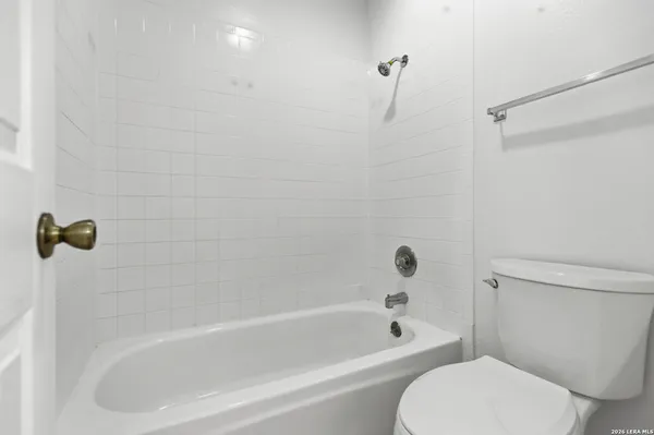 a white bath tub sitting next to a toilet