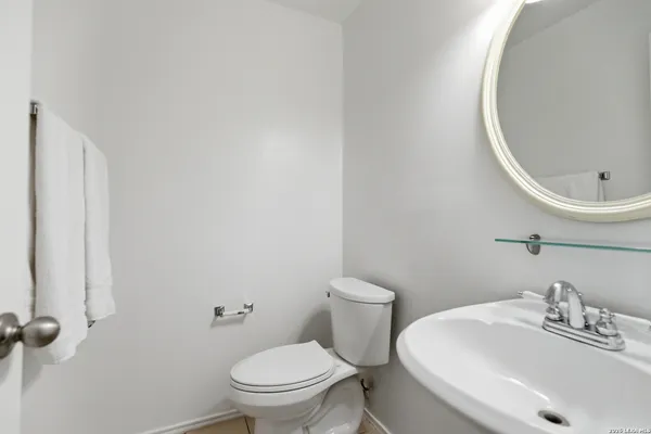 a bathroom with a sink a toilet and a mirror