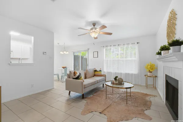 a living room with furniture a fireplace and a chandelier