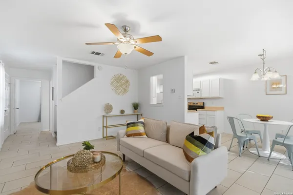 a living room with furniture and kitchen view