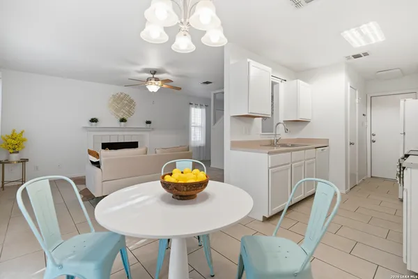 a view of a dining room with furniture and chandelier