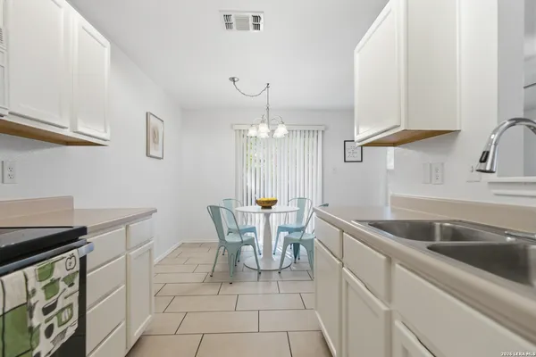 a kitchen with a table chairs and microwave