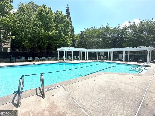 a house view with a swimming pool in front of it