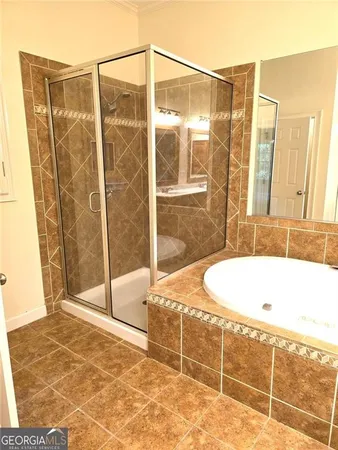 a bathroom with a bathtub and shower