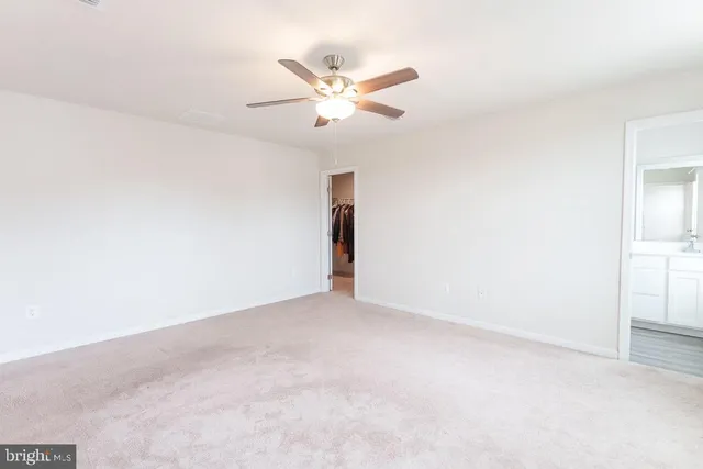 a view of walk in closet with clothes