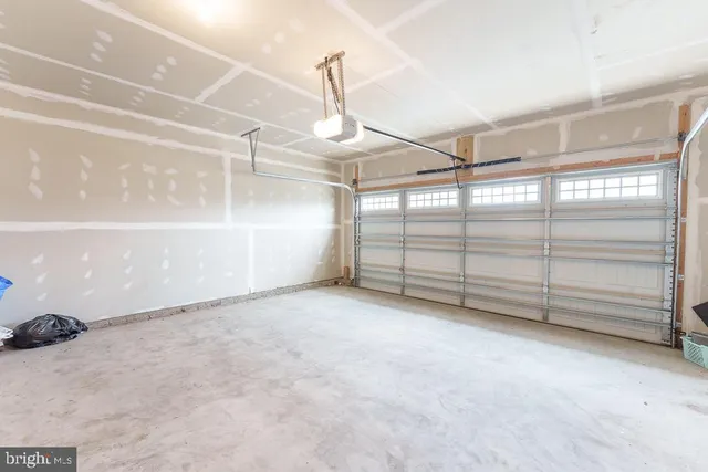 a view of a white house with a yard and plants