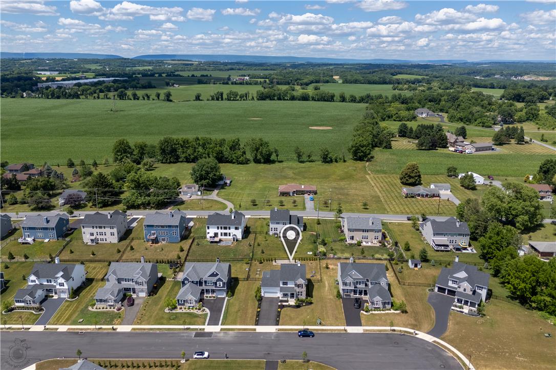 640 Rinaldi Lane Easton, PA 18040 - Photo 37 of 42 An aerial perspective reveals a vibrant neighborhood set against a backdrop of rolling green fields and distant mountains.