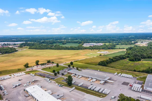 an aerial view of ocean and residential houses with outdoor space