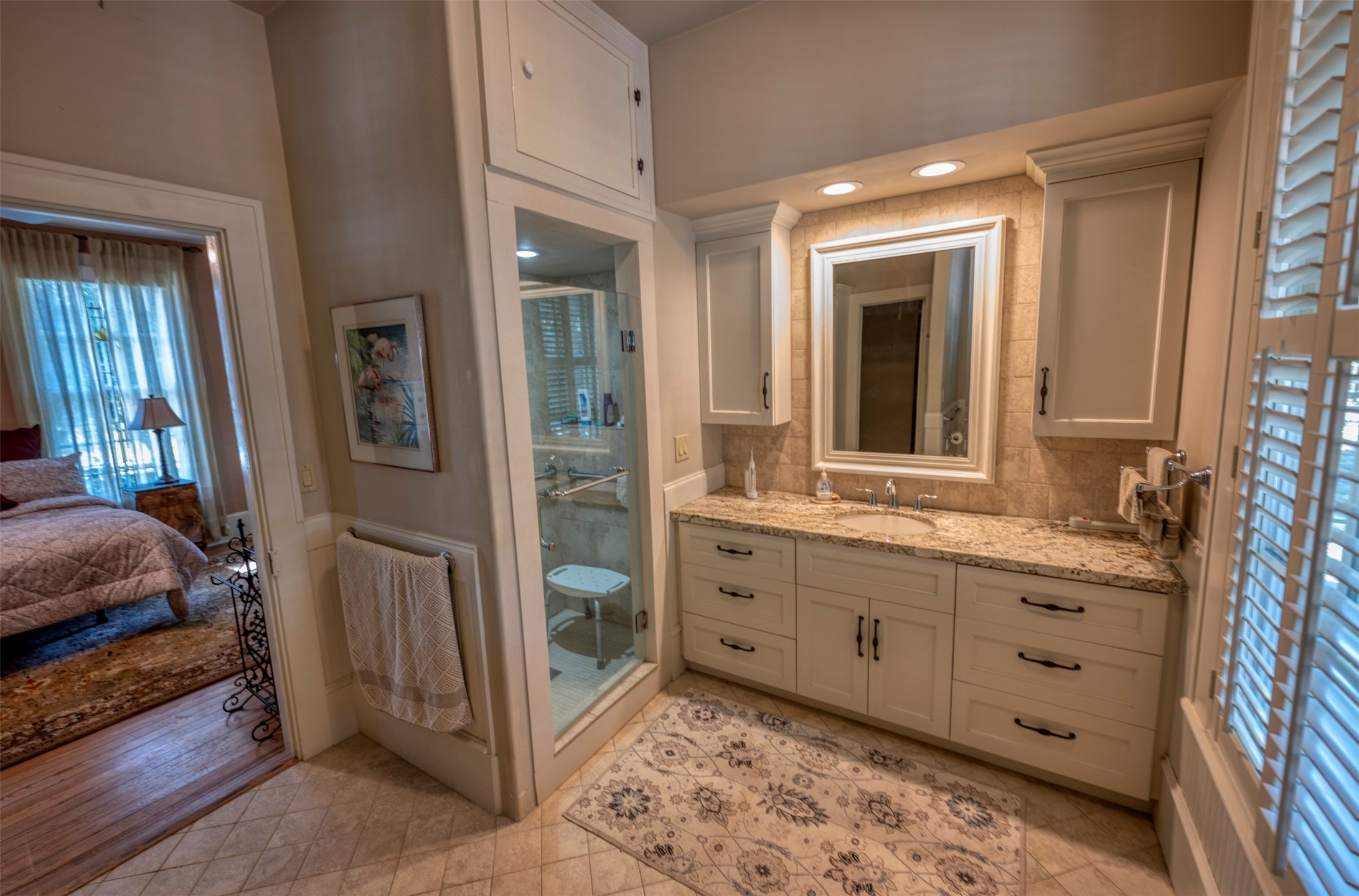 1711 Sempronius Road Chappell Hill, TX 77426 - Photo 19 of 50 a en suite bathroom with a double vanity sink and a mirror