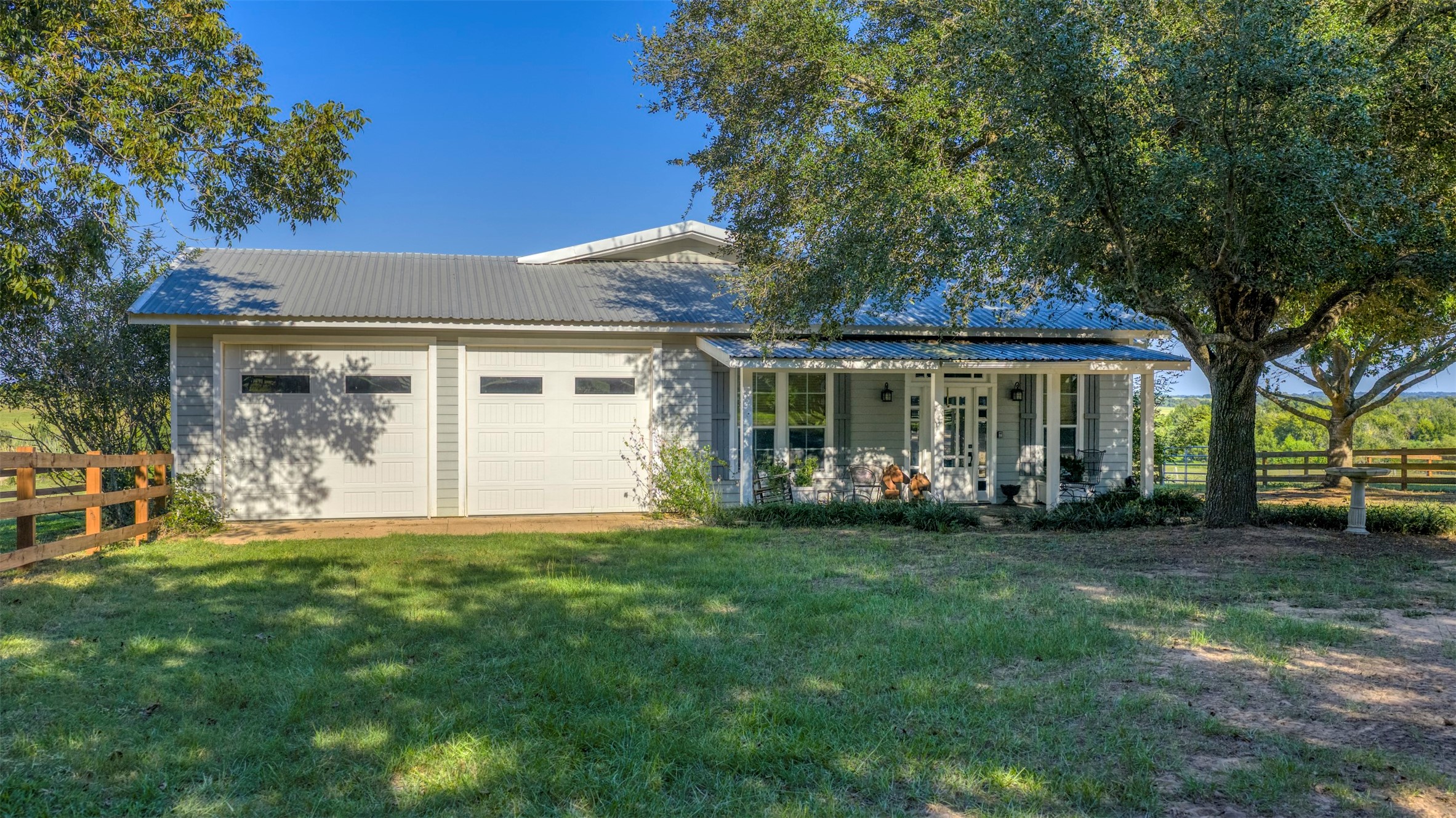 1711 Sempronius Road Chappell Hill, TX 77426 - Photo 30 of 50 a front view of a house with a garden and trees