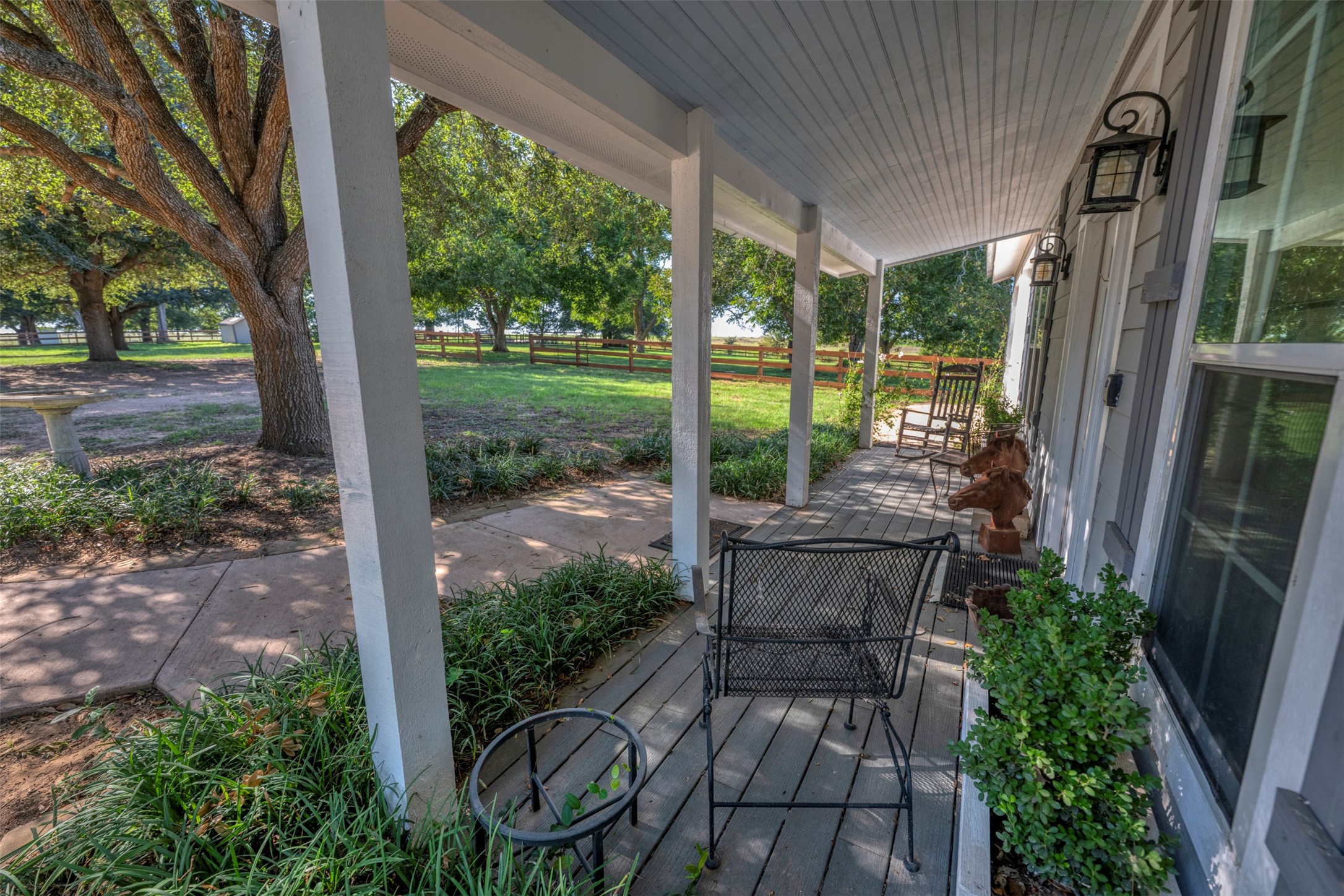 1711 Sempronius Road Chappell Hill, TX 77426 - Photo 31 of 50 a view of a patio with table and chairs potted plants and floor to ceiling window