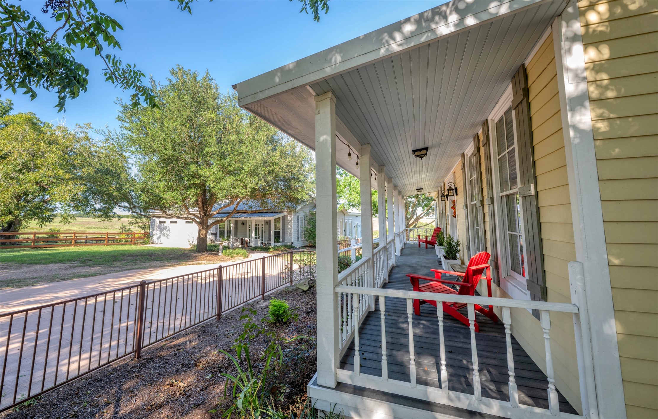 1711 Sempronius Road Chappell Hill, TX 77426 - Photo 8 of 50 a view of a porch with wooden floor and iron fence