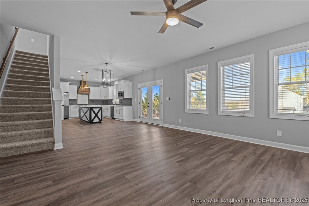 314 Persimmon Tree Drive Cameron, NC 28326 - Photo 11 of 46 a view of a livingroom with wooden floor a ceiling fan and windows