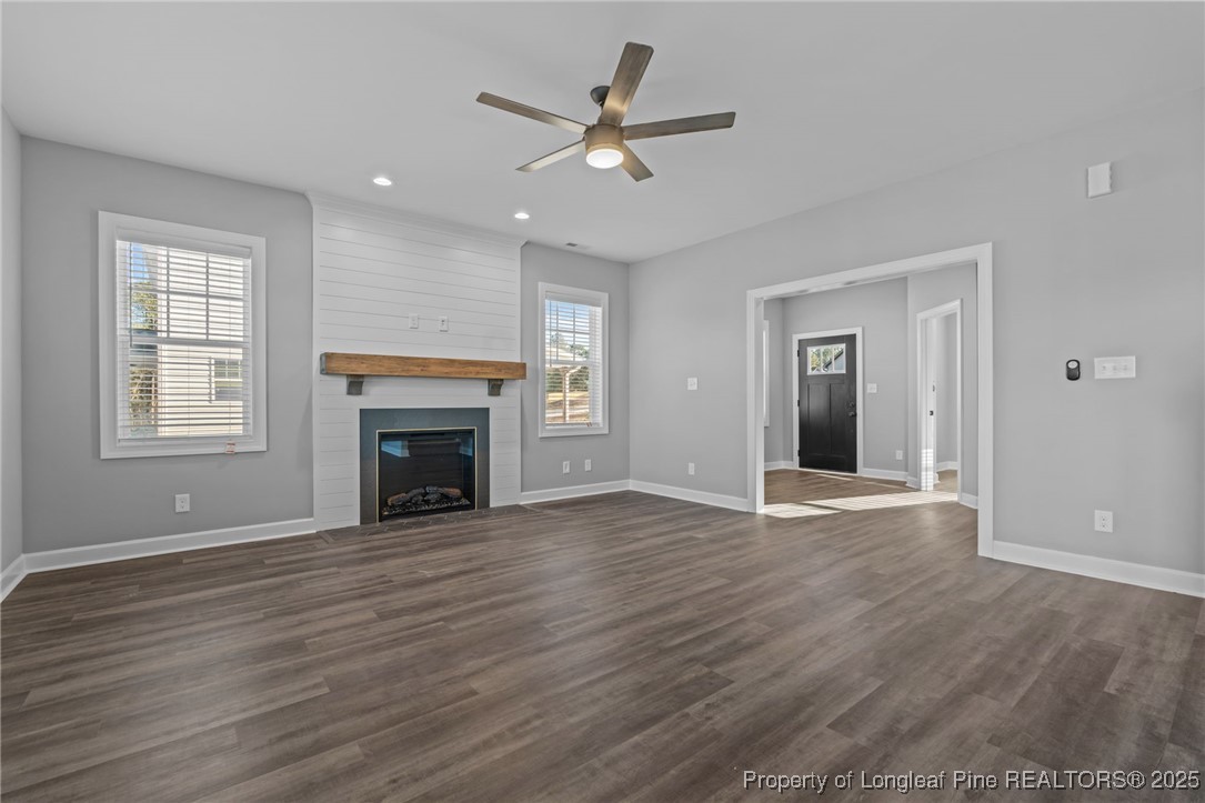 314 Persimmon Tree Drive Cameron, NC 28326 - Photo 12 of 46 a view of an empty room with wooden floor fireplace and a window