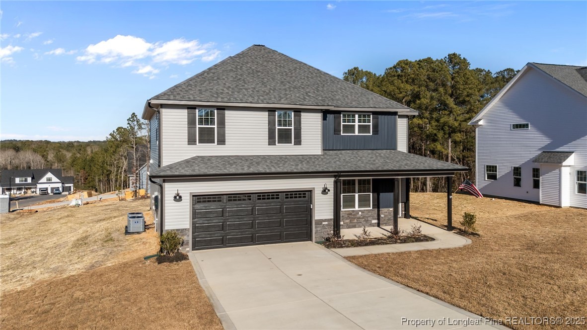 314 Persimmon Tree Drive Cameron, NC 28326 - Photo 2 of 46 a front view of a house with a yard and garage