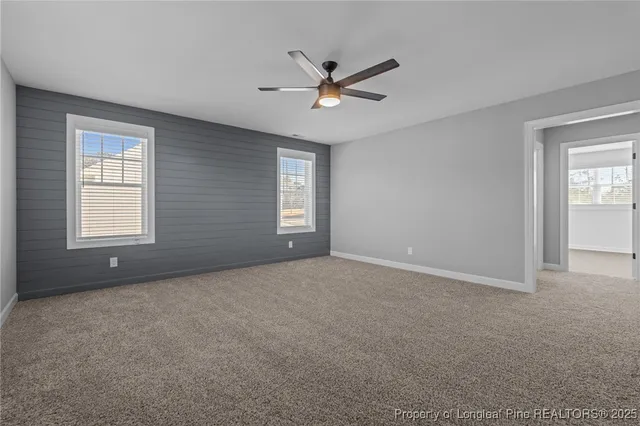 a view of a livingroom with a ceiling fan and window