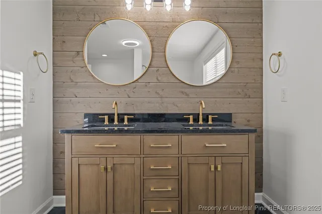 a bathroom with double sink and a mirror