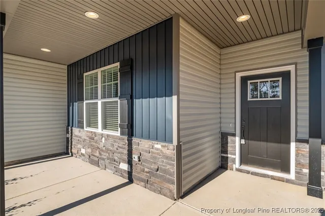 an aerial view of a house with a yard and large trees