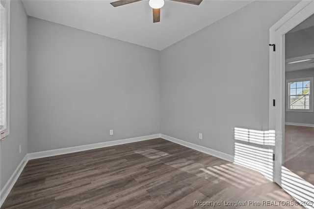 a view of empty room with ceiling fan
