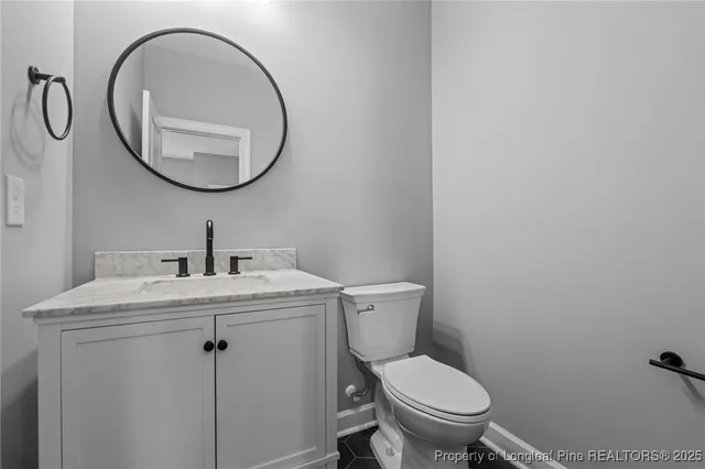 a bathroom with a toilet a sink and a mirror